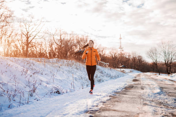 istock Woman running at snowy mountain. 1049942482