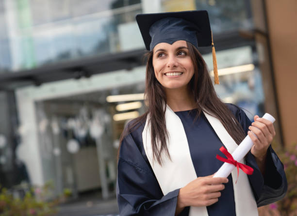 istock Thoughtful female student looking happy on graduation day 1049942702