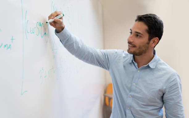 istock Happy college student in class writing on the board 1049942748