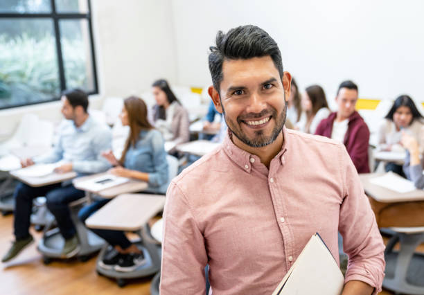 istock Happy man in a classroom with a group of students 1049942766