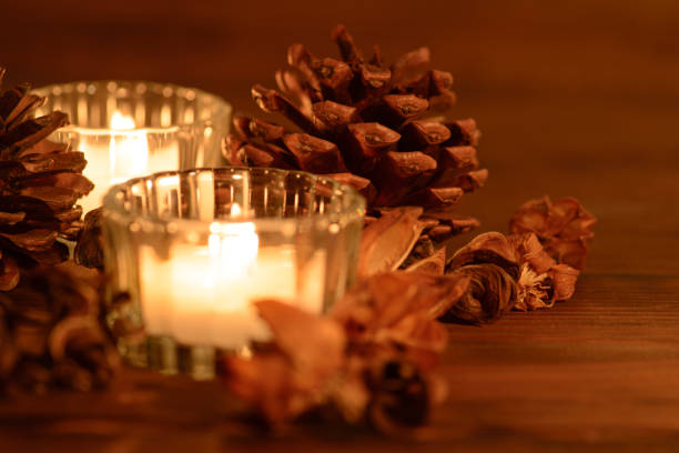 istock Cozy christmas table decoration, candles and pine cones 1049945306