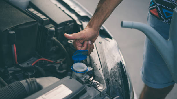 istock Man completing the water of his car 1049945602