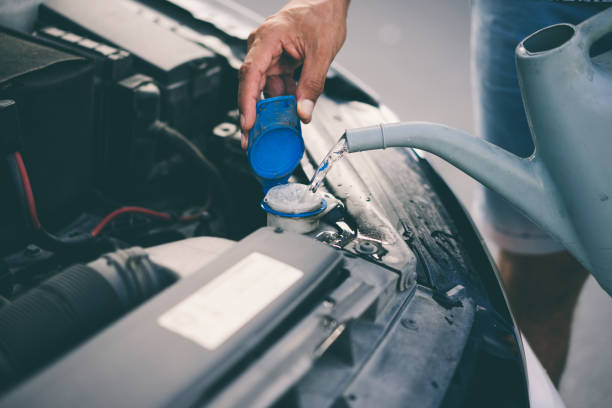 istock Man completing the water of his car 1049945760