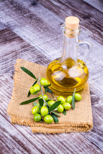 istock Green Olive and olive oil on the background 1049945800
