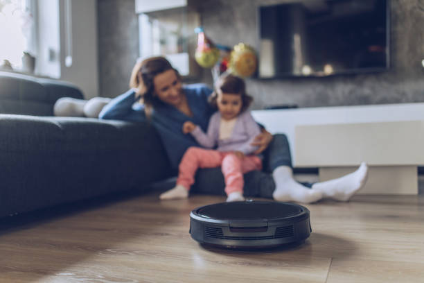 istock Family watching vacuum cleaner cleaning 1049946206