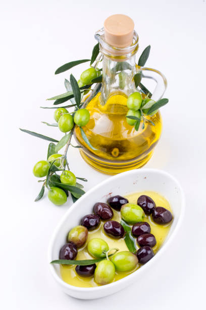 istock Green Olive and olive oil on the background 1049947942