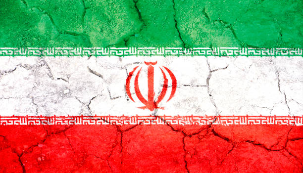 istock Iran flag painted on cracked ground 1049948786