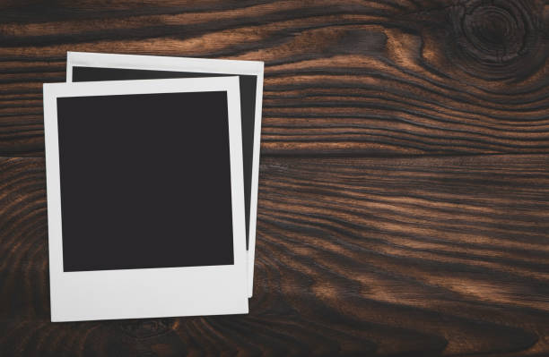 istock Blank frame photo on wood background with space 1049948836