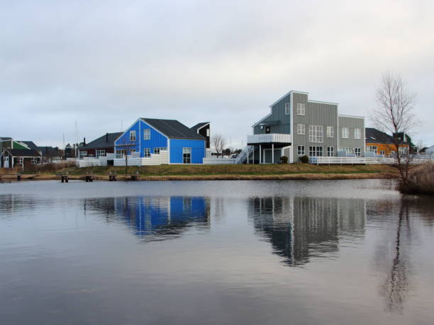 Colorful Houses with Water Reflection and Tree in Denmark. Blue and Grey Wooden Houses.