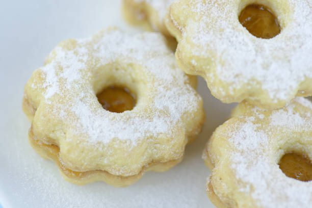istock Homemade apricot jam Linzer on a white plate, close-up 1049953650