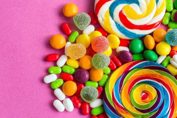 istock Colorful lollipops and different colored round candy. Top view. 1049956072