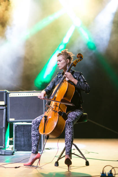 istock Young woman playing cello on the stage 1049956410