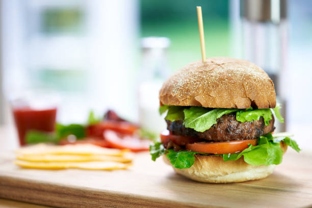 istock A beef burger in a crusty bun with lettuce and tomatoes 1049959056