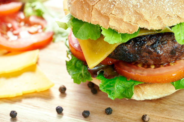 istock A cheese burger in a crusty bun with lettuce and tomatoes 1049960200