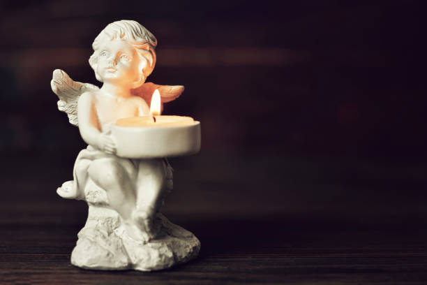 istock Condolence card with an angel holding a burning candle 1049960396