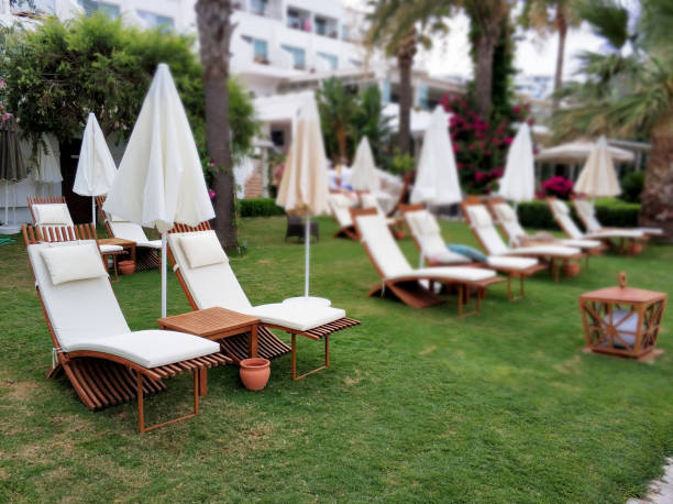 istock Lounge chairs in hotel garden 1049963300