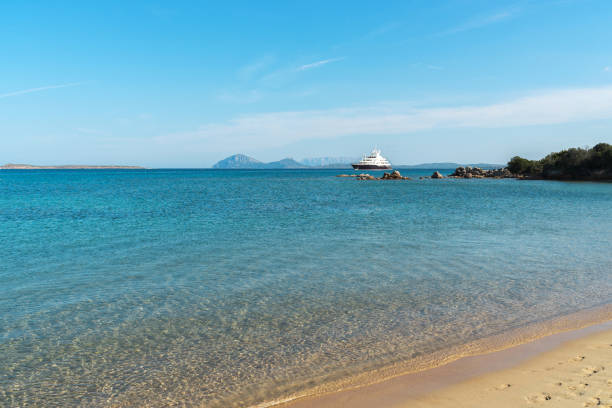 istock Yacht on the horizon on the beach 1049972888