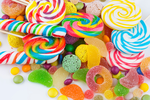 Colorful lollipops and different colored round candy. Top view.