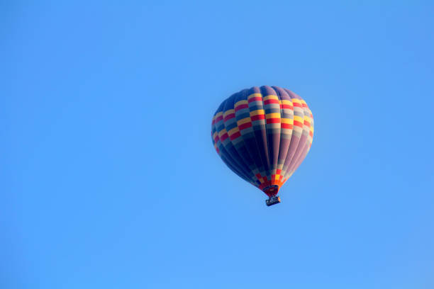 istock Yellow Hot Air Balloon on a Blue Background 1049981614