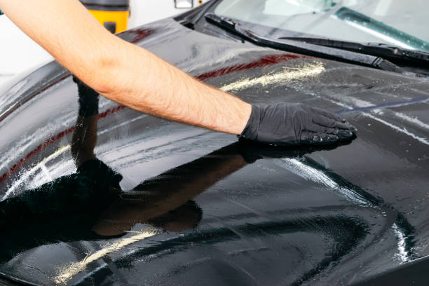 istock A man cleaning car with microfiber cloth, car detailing (or valeting) concept. Selective focus. Car detailing. Cleaning with sponge. Worker cleaning. Microfiber and cleaning solution to clean 1049982406