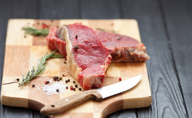 istock fresh raw meat on old wooden table 1049982492