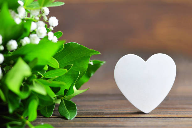 istock Wedding decoration. White heart and white flowers 1049991576