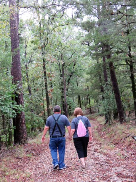 istock Nature walk -- senior couple holding hands 1049991578
