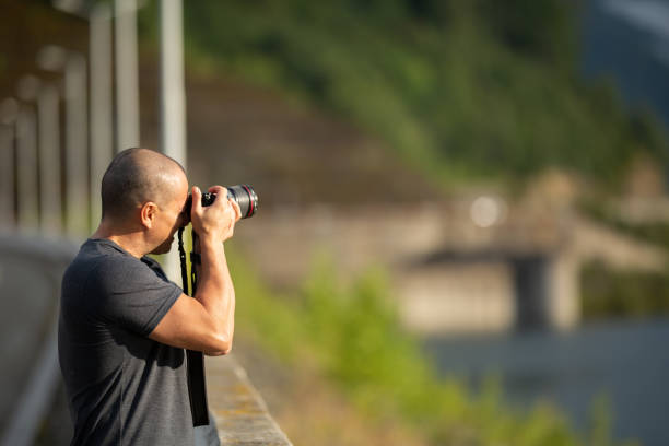 istock Photographer with camera outdoor 1049994764