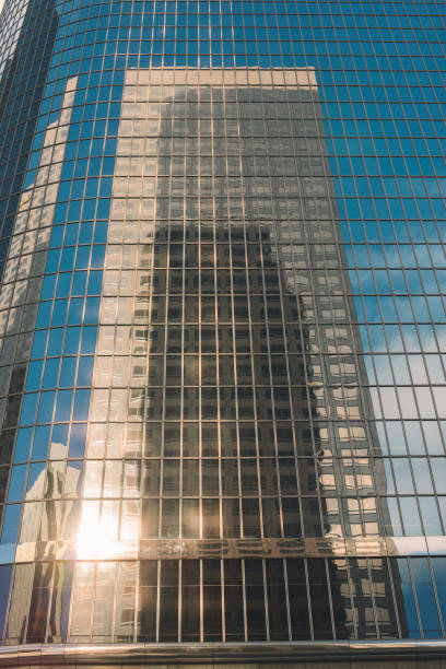 istock Reflection of Sky Scraper Building on an all Glass Building 1049995248