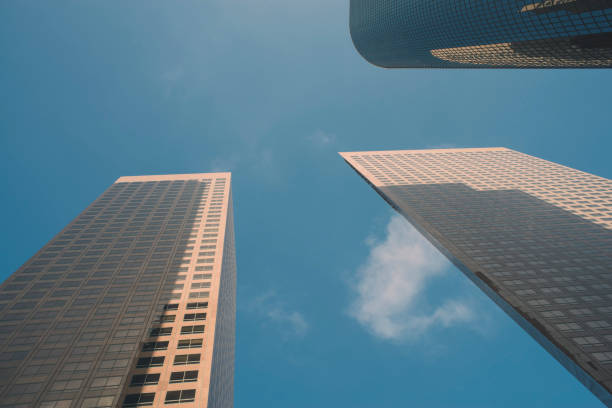 istock Three Sky Scrapers with Blue Sky and Clouds 1049997072