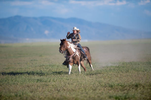 istock Cowgirl Horseback Riding 1049997332
