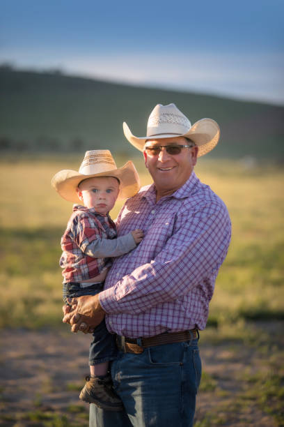 istock Cowboy grandpa with grandson on a field 1050003090