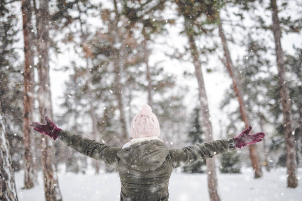 istock Young woman throwing snow 1050003388