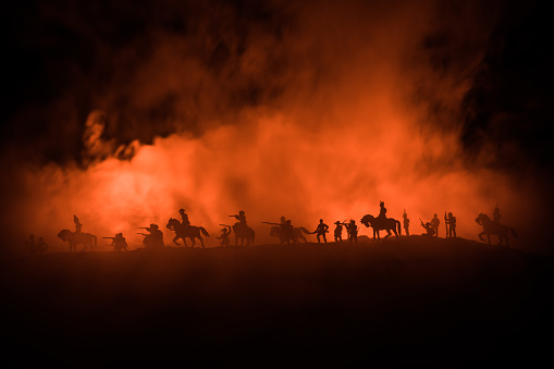 American Civil War Concept. Military silhouettes fighting scene on war fog sky background. Attack scene. Selective focus