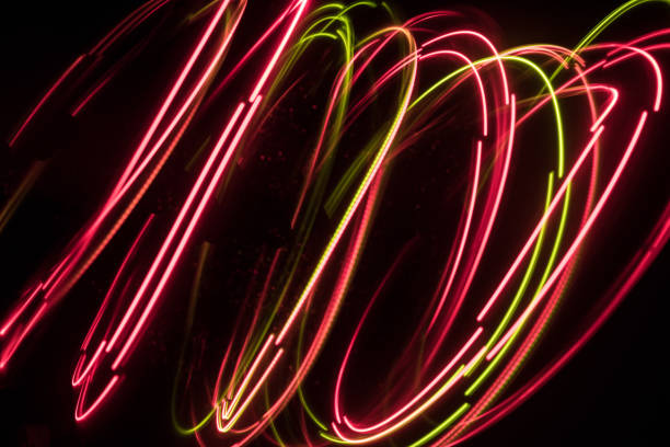 istock Overlaying wavy lines forming an abstract pattern on a dark background. Long exposure light background. 1050010924