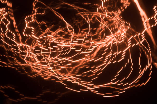 istock Overlaying wavy lines forming an abstract pattern on a dark background. Long exposure light background. 1050011168