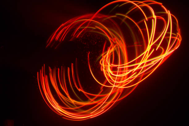 istock Overlaying wavy lines forming an abstract pattern on a dark background. Long exposure light background. 1050012302
