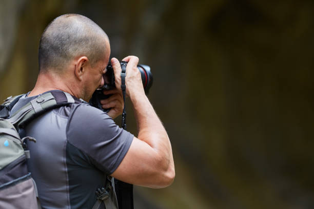 istock Photographer with camera outdoor 1050013442