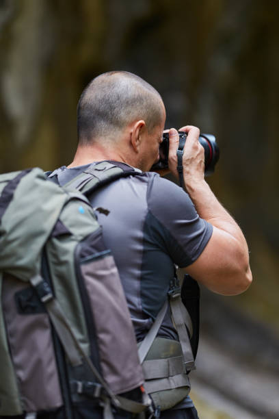 istock Photographer with camera outdoor 1050013448