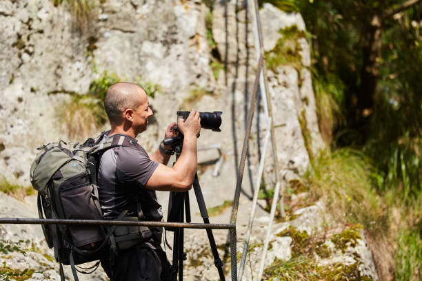 istock Photographer with camera outdoor 1050013454