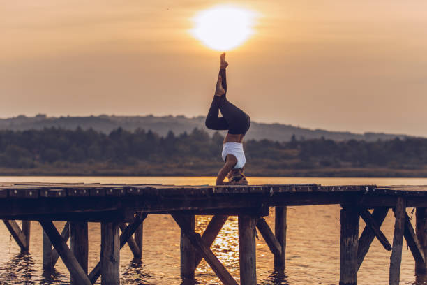 istock Woman doing yoga at the jetty 1050015724