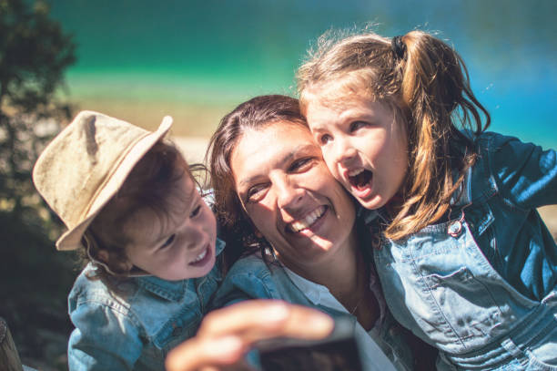 istock Family in a forest taking selfie group portrait 1050018778