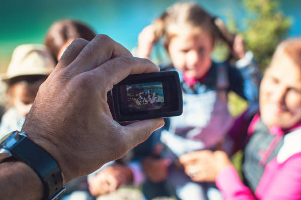 Family on picnic in a forest taking selfie group portrait