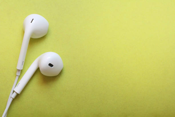 istock White earphones on a green background 1050021240