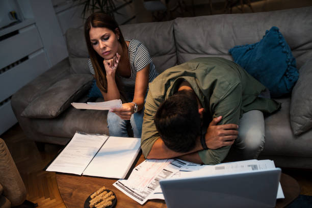 istock Worried young couple with financial bills 1050026816