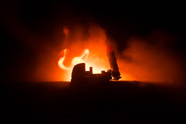 istock Rocket launch with fire clouds. Battle scene with rocket Missiles with Warhead Aimed at Gloomy Sky at night. Rocket vehicle on War Backgound 1050026924