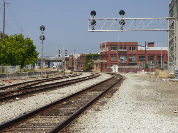istock Empty tracks curve past old brick warehouses in Oakland, CA. 1050029438