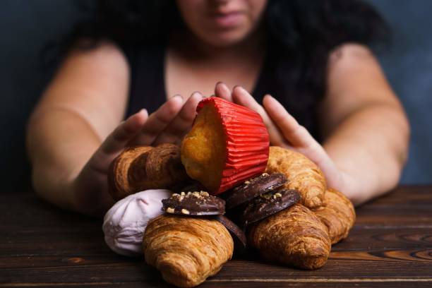 Young woman refuse eating junk food Sugar addiction, nutrition choices, motivation and healthy lifestyle. Cropped portrait of overweight woman refusing sweet food over eating stock pictures, royalty-free photos & images