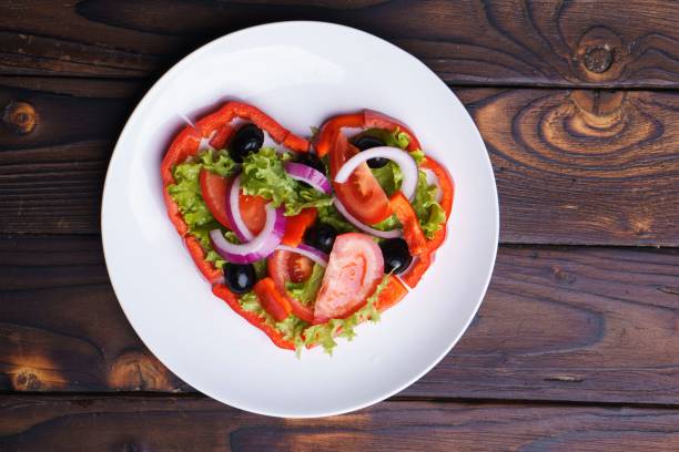 istock Heart shaped salad of raw vegetables on plate 1050035378