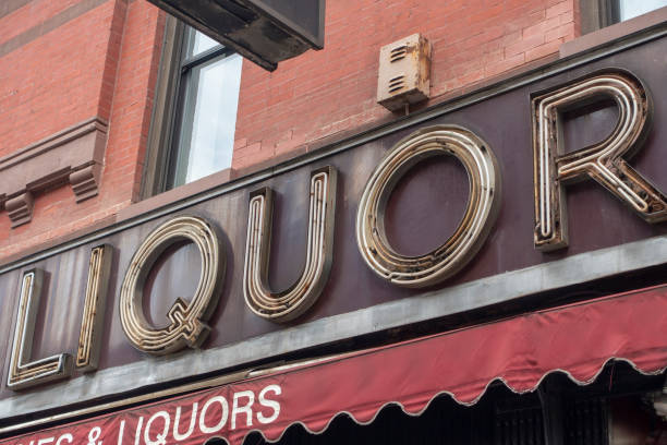 Advertising storefront neon lights reading Liquor daylight light not on